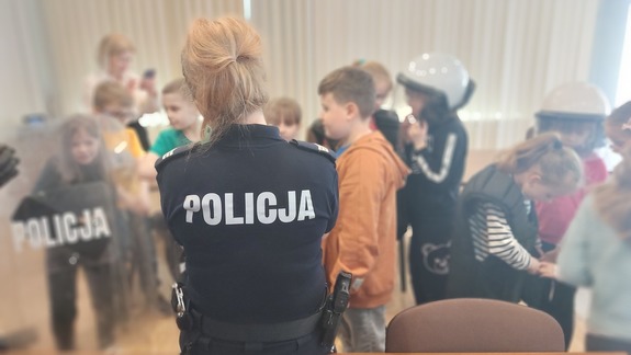 spotkanie policjantów z dziećmi ze szkoły podstawowej nr 5 w Przemyślu. Uczniowie oglądają wyposażenie policjanta na służbie.
