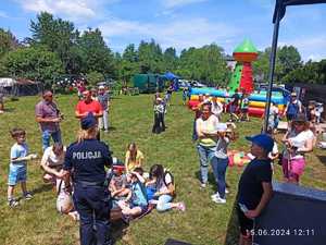 Zdjęcie z policjanta z dziećmi z pikniku rodzinnego.