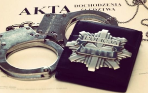 odznaka policyjna wraz kajdankami